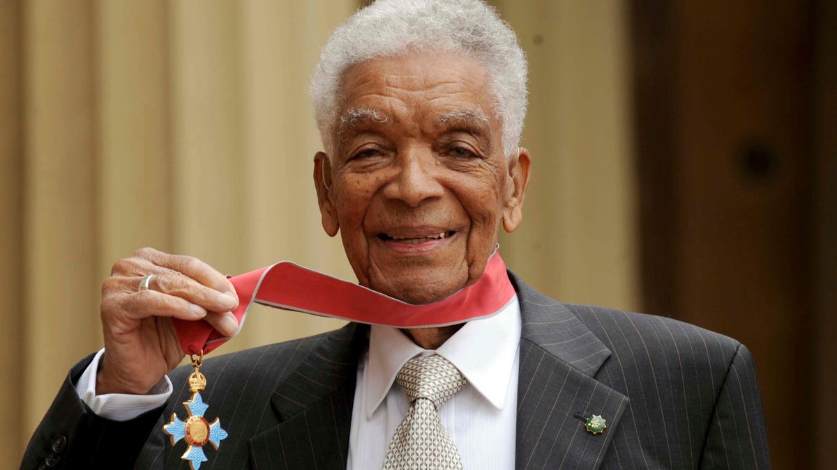 Earl Cameron outside Buckingham Palace after being presented his CBE by Prince Charles, in London. (Anthony Devlin/PA via AP, file)