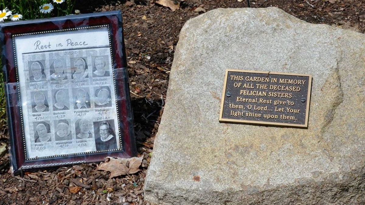 A small memorial to the 12 sisters who died in one month from COVID-19 sits in the gardens outside the Felician Sisters' convent in Livonia, Mich.