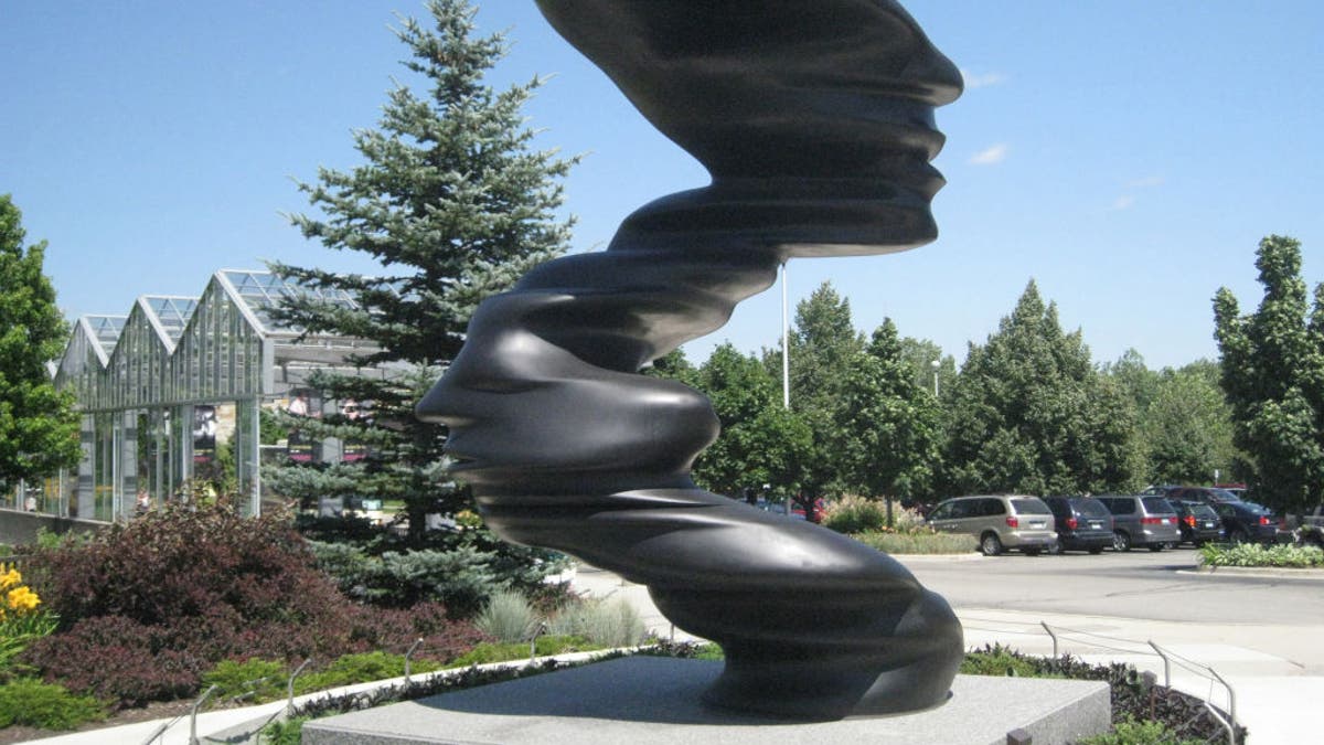 The 15-foot bronze sculpture, "Bent of Mind," by Tony Cragg, graces the entrance to Frederik Meijer Gardens and Sculpture Park in Grand Rapids, Mich.