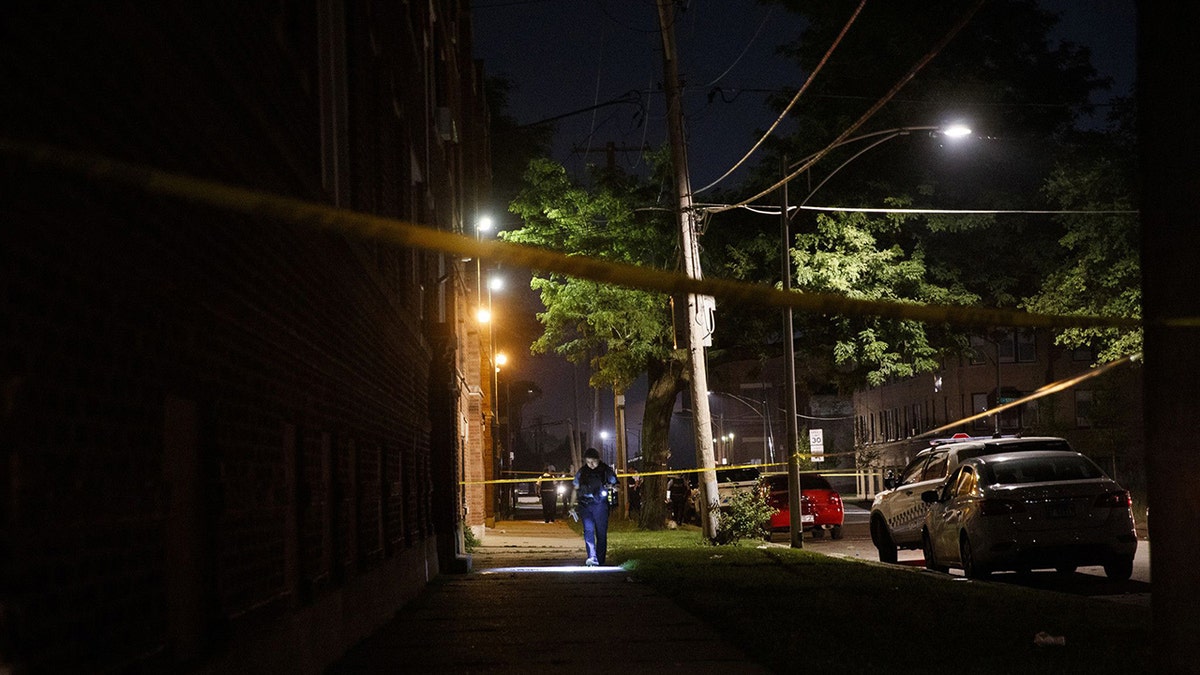 Police work the scene where a 19-year-old man was shot in the 400 block of West 77th Street in Chicago on July 3, 2020.