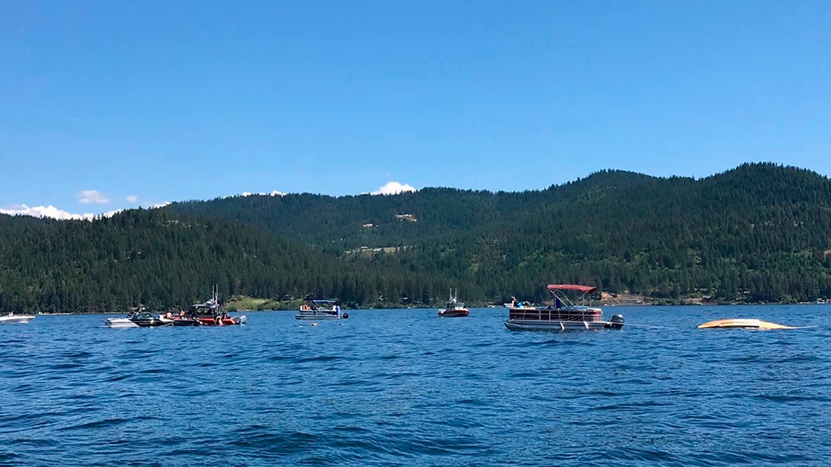 Boaters flag down authorities to a crashed seaplane near Powderhorn Bay on Lake Coeur d'Alene on Sunday, July 5, 2020, south of Coeur d'Alene, Idaho. (Stephanie Hammett/The Spokesman-Review via AP)