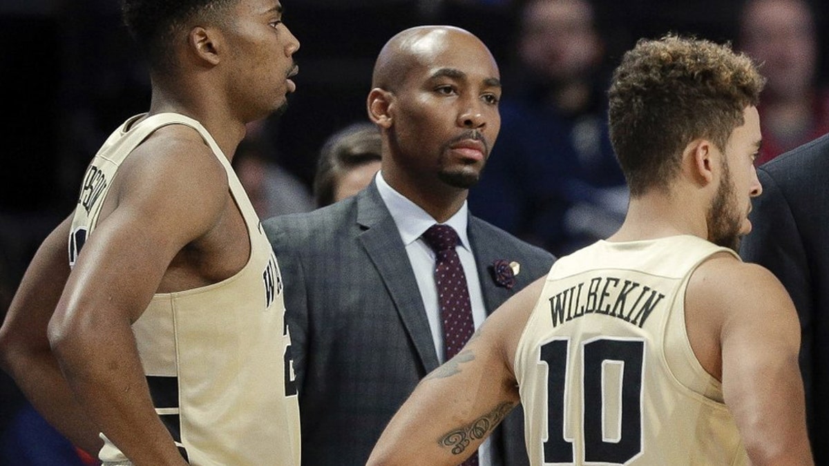 This Nov. 28, 2017 photo shows former Wake Forest assistant coach Jamill Jones, center, during the second half of an NCAA college basketball game in Winston-Salem, N.C. (AP Photo/Chuck Burton)
