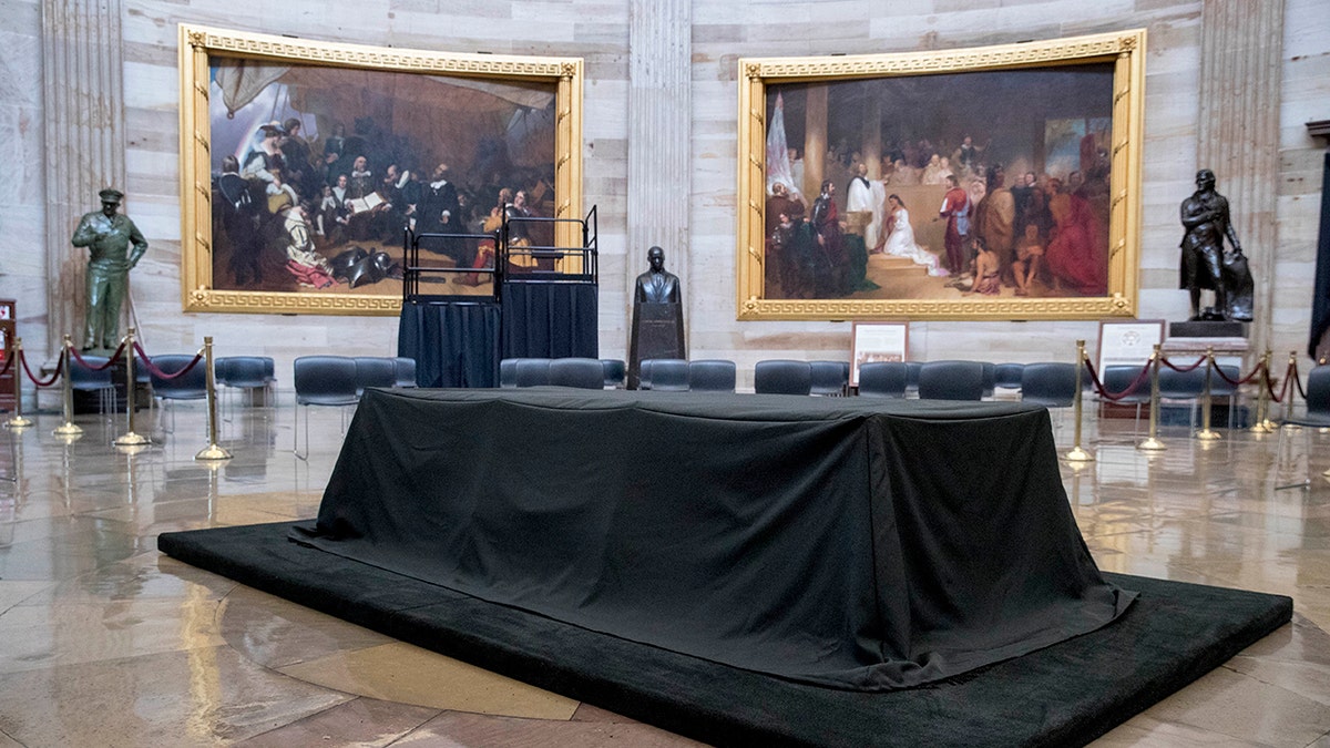 A bust of Martin Luther King, Jr., center, is visible behind the catafalque for the casket of the late Rep. John Lewis, D-Ga., in the center of the U.S. Capitol Rotunda in Washington, Friday, July 24, 2020, before he lies in state Monday. Lewis, who carried the struggle against racial discrimination from Southern battlegrounds of the 1960s to the halls of Congress, died Friday, July 17, 2020. (AP Photo/Andrew Harnik)
