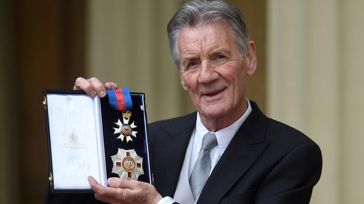 British actor and television presenter Michael Palin poses with his medals after being appointed a Knight Commander of the Order of St Michael and St George (KCMG) during an investiture ceremony at Buckingham Palace in London on June 12, 2019.