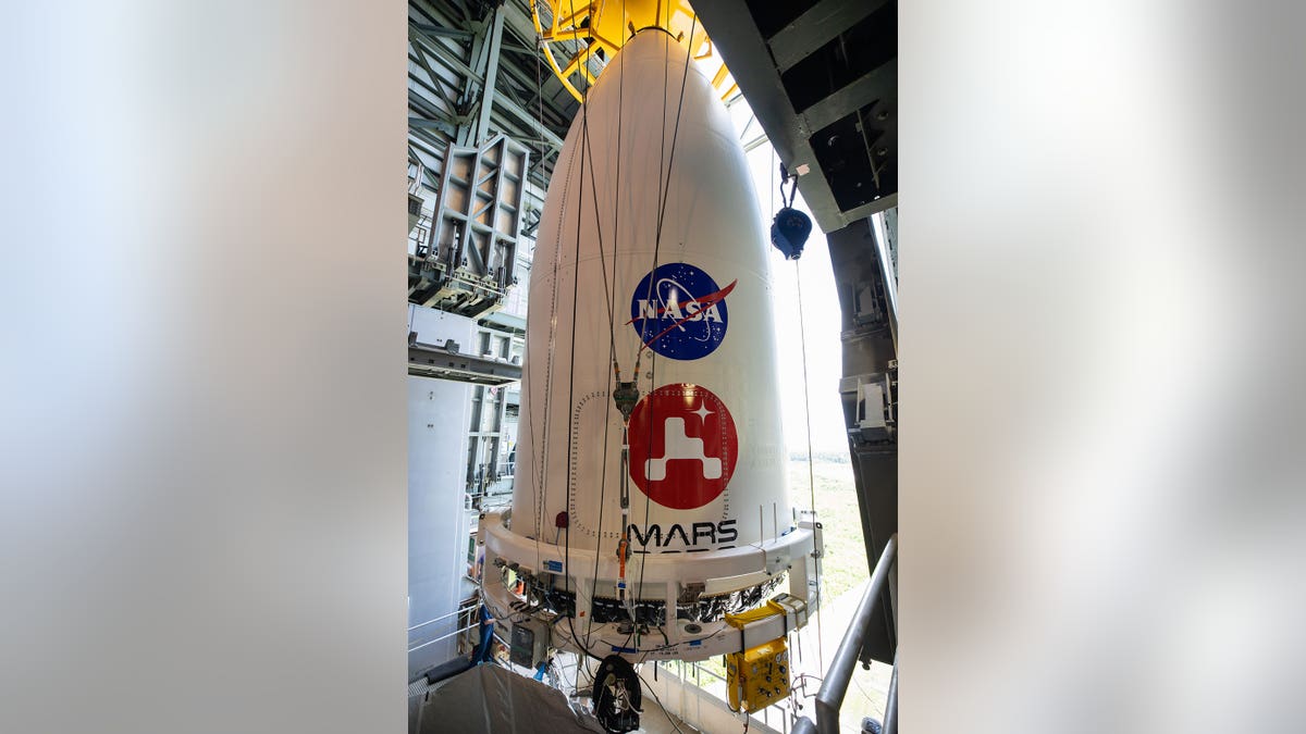 The nose cone containing NASA's Mars 2020 Perseverance rover is maneuvered into place atop its Atlas V rocket. The image was taken at Cape Canaveral Air Force Station in Florida on July 7, 2020.