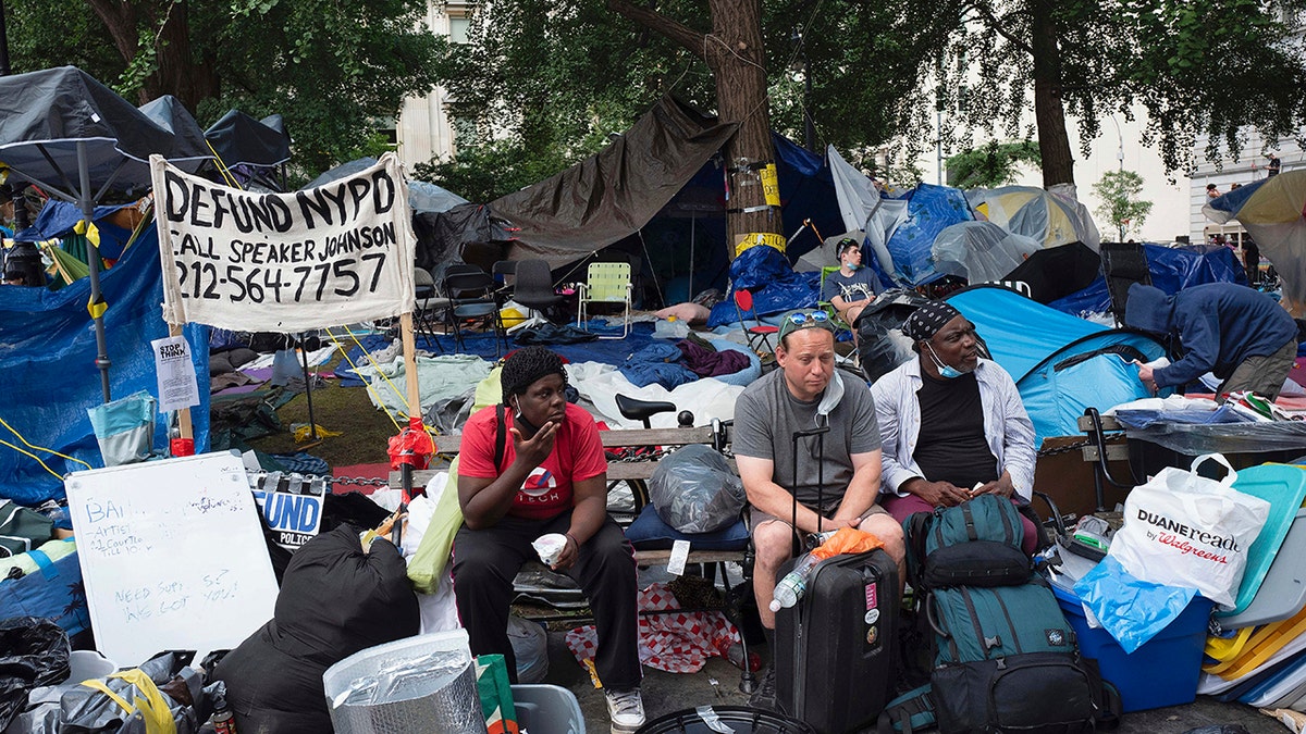 Protesters sit in their encampment, adjacent to City Hall. in New York, Wednesday, July 1, 2020. (AP Photo/Mark Lennihan)