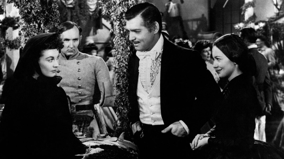 Actors Vivien Leigh, Clark Gable and Olivia De Havilland play the roles of Scarlett O'Hara, Rhett Butler and Melanie Hamilton respectively in Gone with the Wind by Victor Fleming. United States. 1939. (Photo by Mondadori via Getty Images)