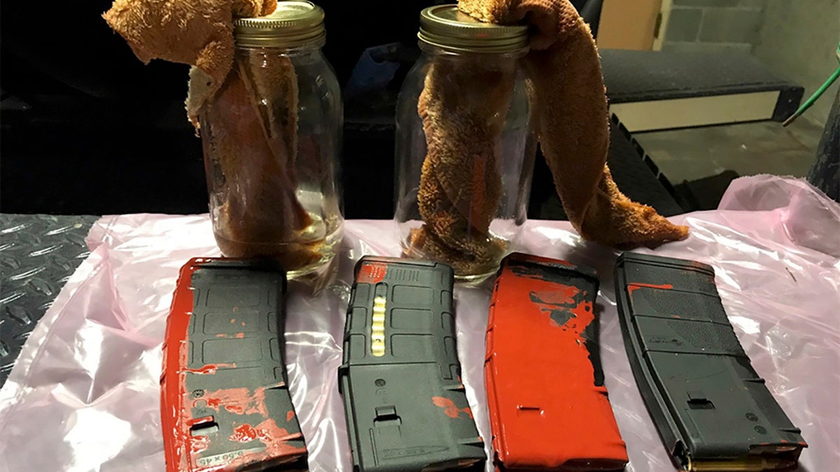 This photo posted Sunday, July 26, 2020, by the Portland Police Department on their Twitter page shows items the police say were loaded rifle magazines and Molotov cocktails found at a park in Portland, Oregon. (Portland Police Department via AP)