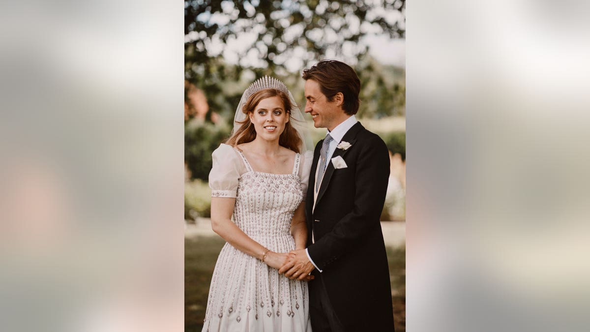 In this photograph released on Sunday, July 19, 2020, by the Royal Communications of Princess Beatrice and Edoardo Mapelli Mozzi, showing Britain's Princess Beatrice and Edoardo Mapelli Mozzi as they pose for a photo on Friday July 17, 2020, after their wedding at The Royal Chapel of All Saints at Royal Lodge, Windsor, England. (Benjamin Wheeler/Royal Communications of Princess Beatrice and Edoardo Mapelli Mozzi via AP)