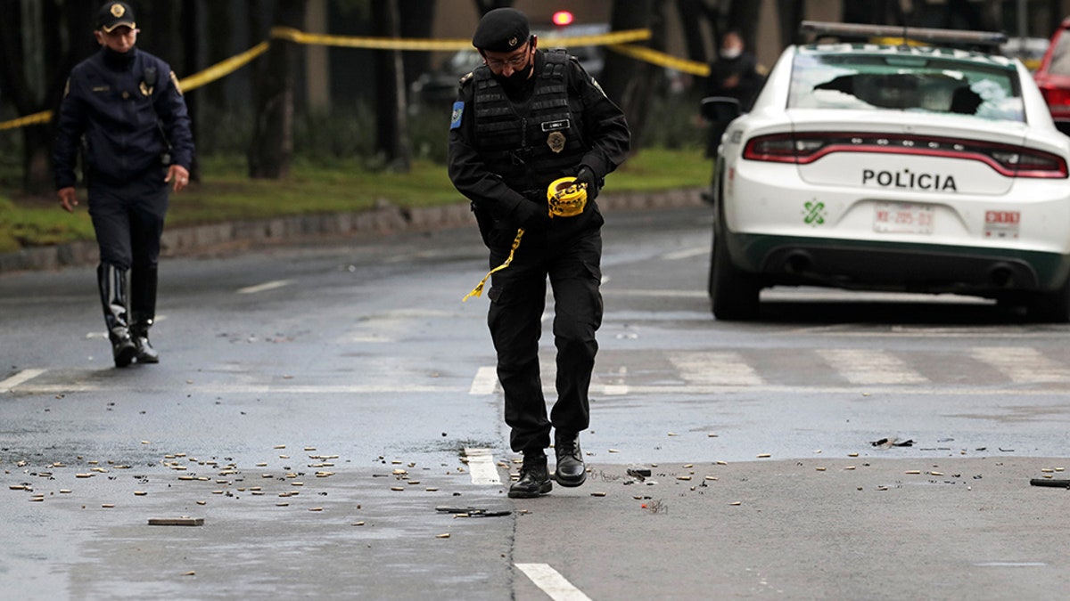 A police officer walks amid ammunition near the scene of a shooting in Mexico City, Mexico, June 26, 2020. (Reuters/Henry Romero)