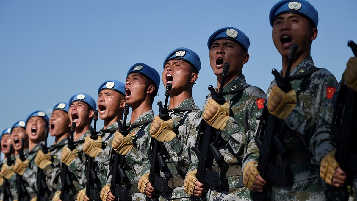 Chinese troops take part in marching drills ahead of an October 1 military parade to celebrate the 70th anniversary of the founding of the People's Republic of China at a camp on the outskirts of Beijing, China September 25, 2019. Wang Zhao/Pool via REUTERS - RC1F4A580FC0