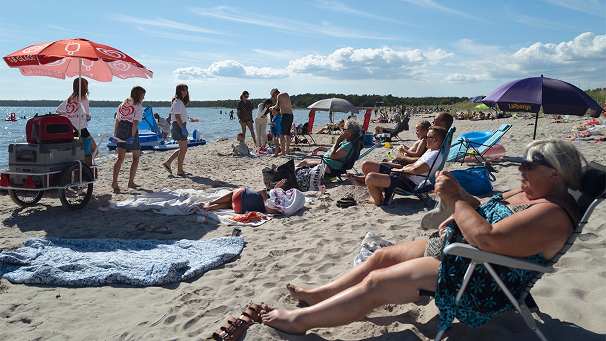 People gather on a beach on July 17, 2020 in Gotland, Sweden. (Martin von Krogh/Getty Images)