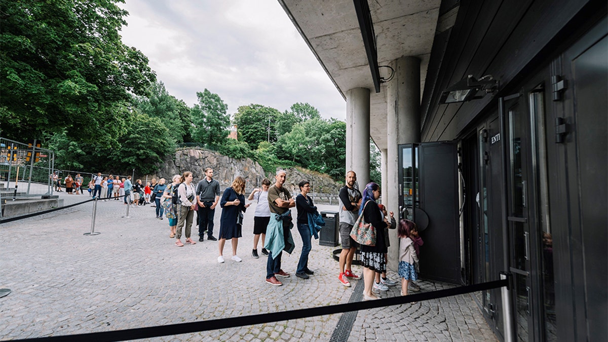 People queue to visit the Vasa Museum in Stockholm on July 15, 2020 on the day of its reopening amid the new coronavirus pandemic. (STINA STJERNKVIST/TT News Agency/AFP via Getty Images)