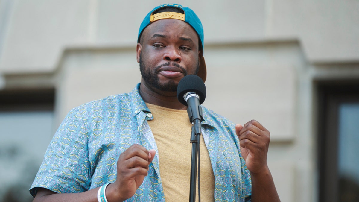 Vauhxx Booker speaks during a community gathering to fight against racism. (SOPA Images/LightRocket via Getty Images)