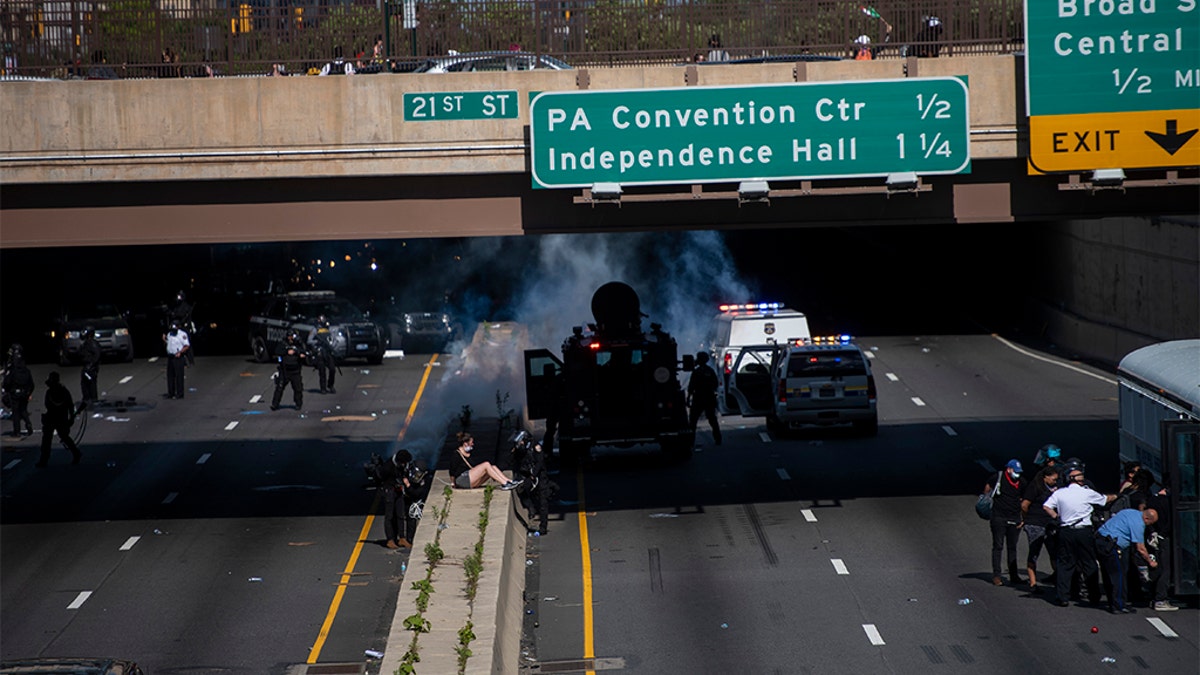 An arrested protester sitting on a barrier on the Vine Street Expressway in Philadelphia on June 1. (Mark Makela/Getty Images, File)
