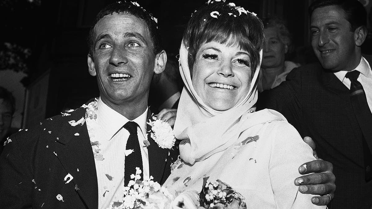 In this Aug. 19, 1963, file photo, British jazz singer Annie Ross, right, and actor Sean Lynch are covered with confetti after their marriage in London. Ross, who rose to fame as a jazz singer in the 1950s, struggled with personal problems in the '60s, faded from the spotlight in the '70s, re-emerged as a successful character actress in the '80s and finished her career as a cabaret mainstay, died on July 21 at her home in New York.
