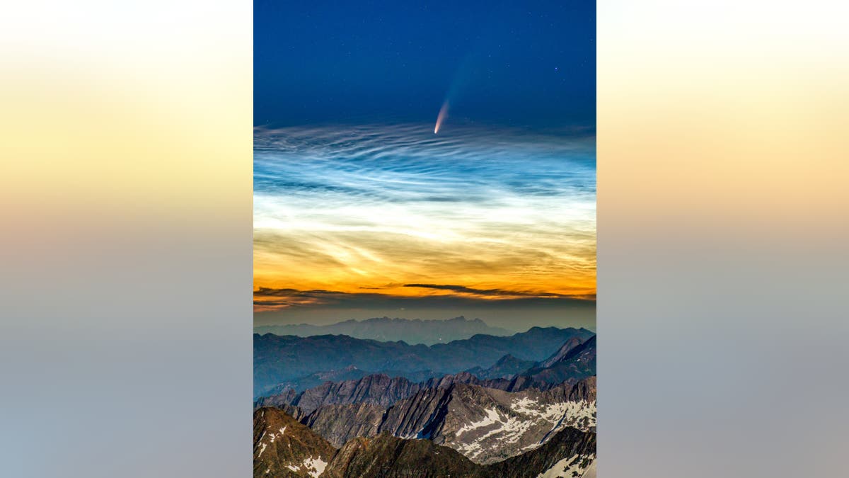 The NEOWISE comet seen above noctilucent clouds taken from the Hochfeiler mountain in the South Tyrol alps in Italy on July 8. (Credit: SWNS)