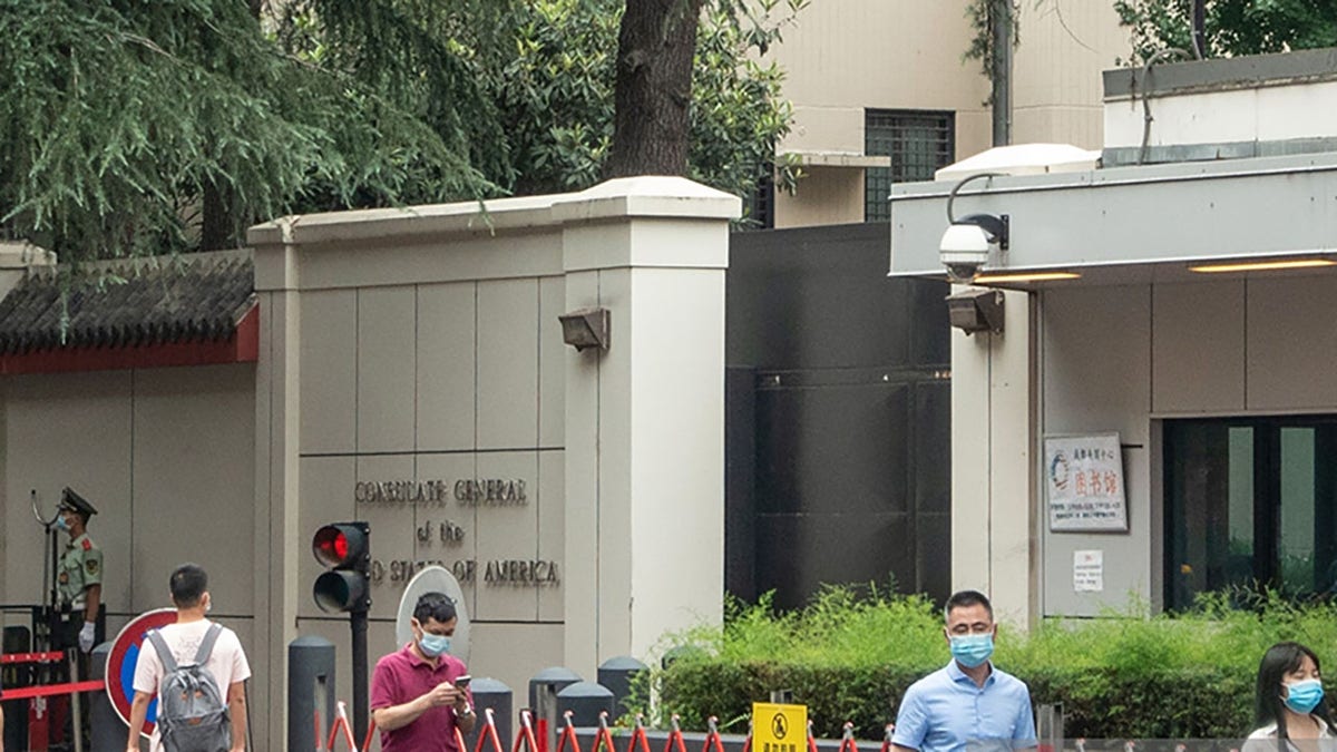 This photo taken on July 23, 2020 shows people walking past the entrance of the US consulate in Chengdu, southwest China's Sichuan province. China on July 24 ordered the closure of the U.S. consulate in the southwestern city of Chengdu, in retaliation for America shuttering Beijing's diplomatic mission in Houston this week.  (Photo by STR/AFP via Getty Images)