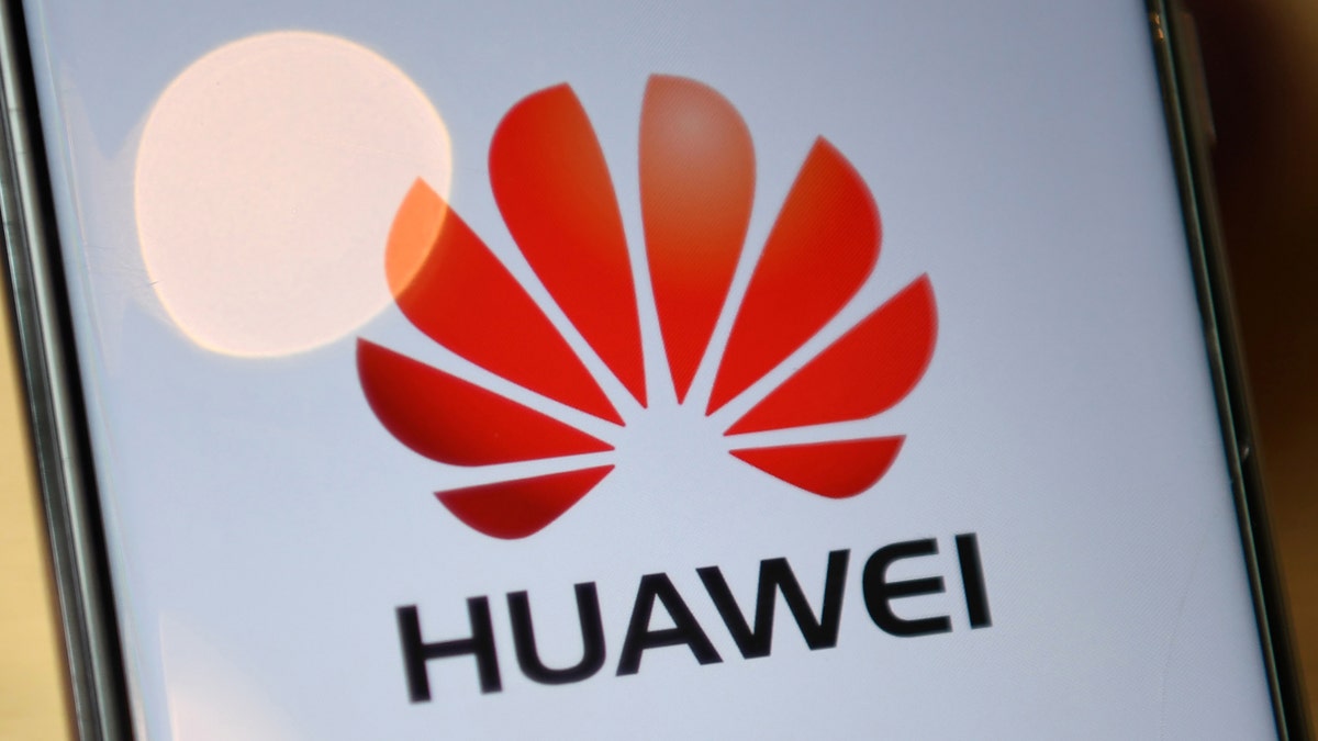 The logo of Chinese company Huawei is seen on the screen of a Huawei mobile phone in London on July 14, 2020. 