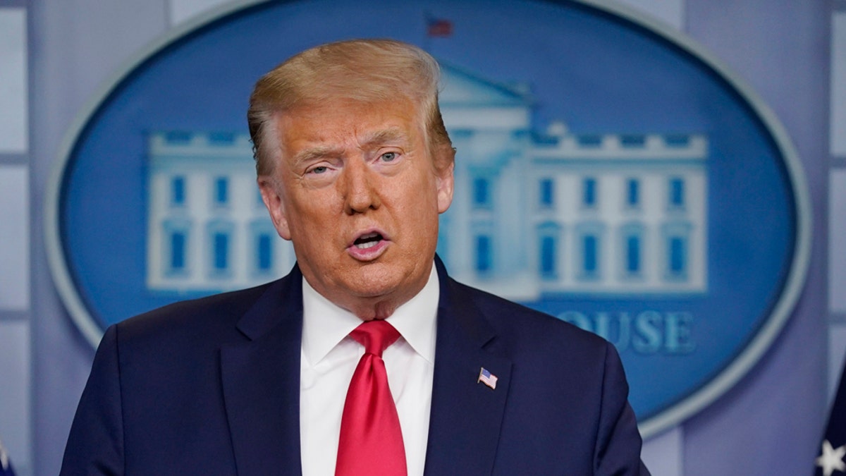 Then-President Trump speaks during a news briefing at the White House.