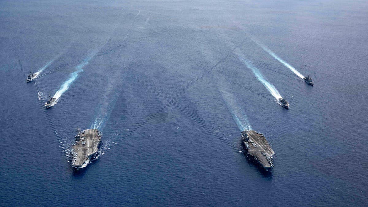In this photo provided by U.S. Navy, the USS Ronald Reagan (CVN 76) and USS Nimitz (CVN 68) Carrier Strike Groups steam in formation, in the South China Sea, Monday, July 6, 2020 - file photo. (Mass Communication Specialist 3rd Class Jason Tarleton/U.S. Navy via AP)