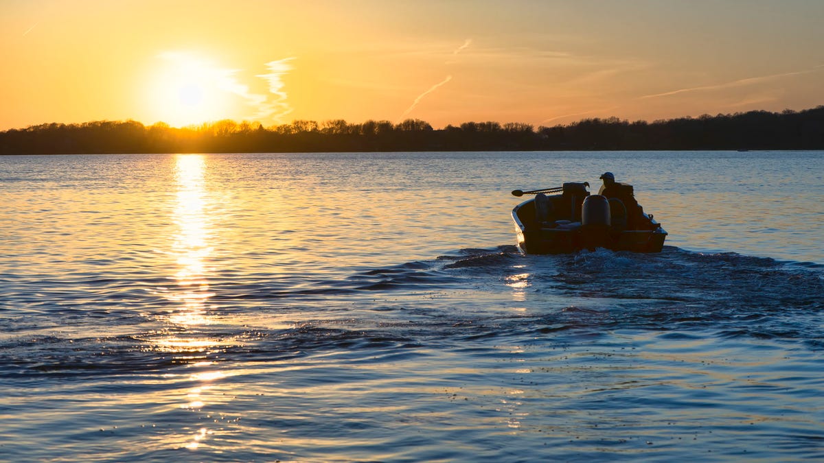 Silhouette of fishing boat on a lake