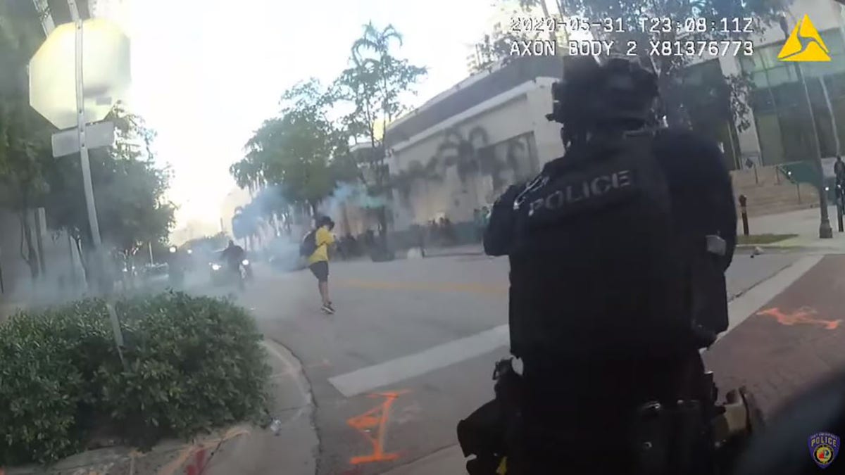 Police are seen in the video firing rubber bullets at a protester who threw a gas canister back at officers during the protest on May 31.