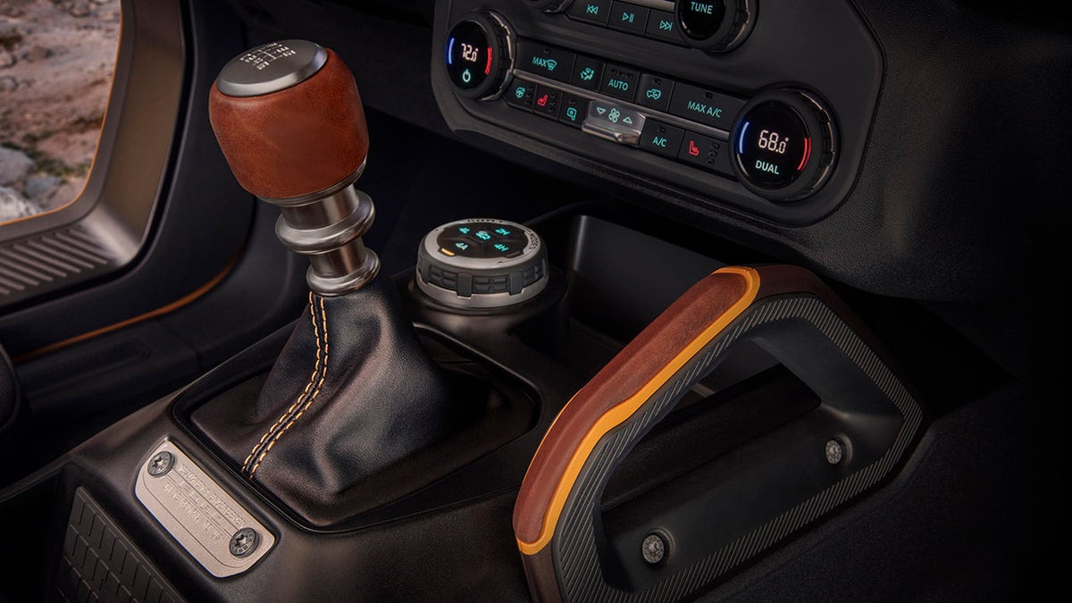 Customization details include an available leather-wrapped shift lever for the class-exclusive 7-speed manual transmission, as well as grab handles in this prototype version of the 2021 Bronco (not representative of production model). (Static display on private property with aftermarket accessories not available for sale.)