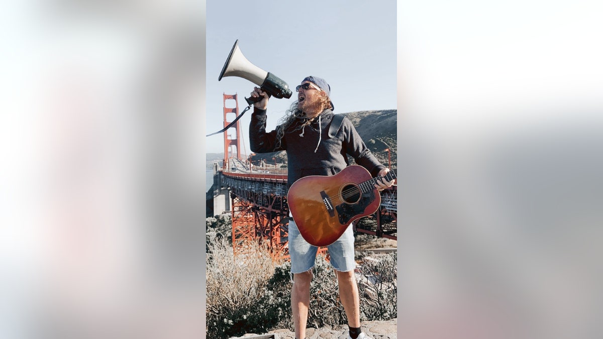 Sean Feucht, Hold The Line founder, leads worship at the Golden Gate Bridge on Thursday, July 9, 2020. Between 300 and 400 gathered to protest the state's ban on singing in churches due to a surge in coronavirus cases, organizers said.