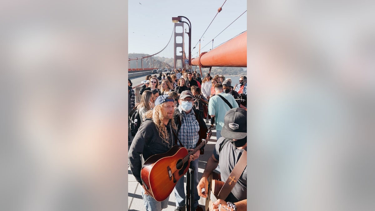 Sean Feucht, Hold The Line founder, leads worship at the Golden Gate Bridge on Thursday, July 9, 2020. Between 300 and 400 gathered to protest the state's ban on singing in churches due to a surge in coronavirus cases, organizers said.