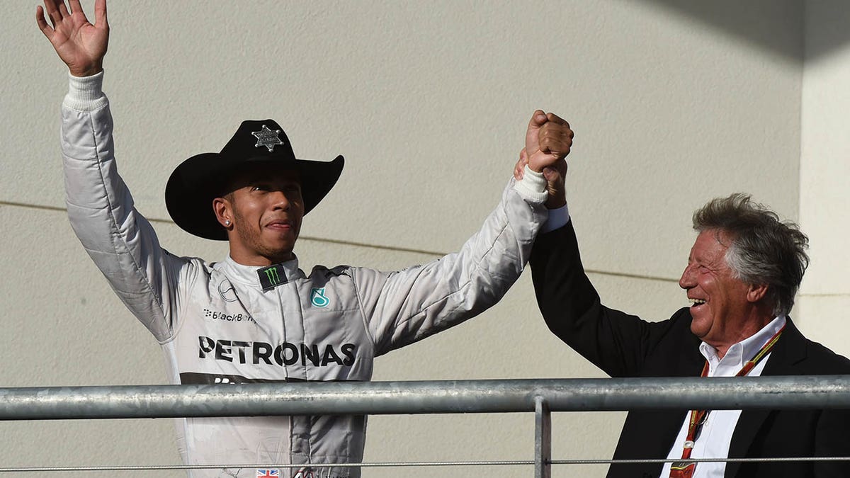 Andretti celebrated with Hamilton after the British driver's win at the United States Formula One Grand Prix in 2014.