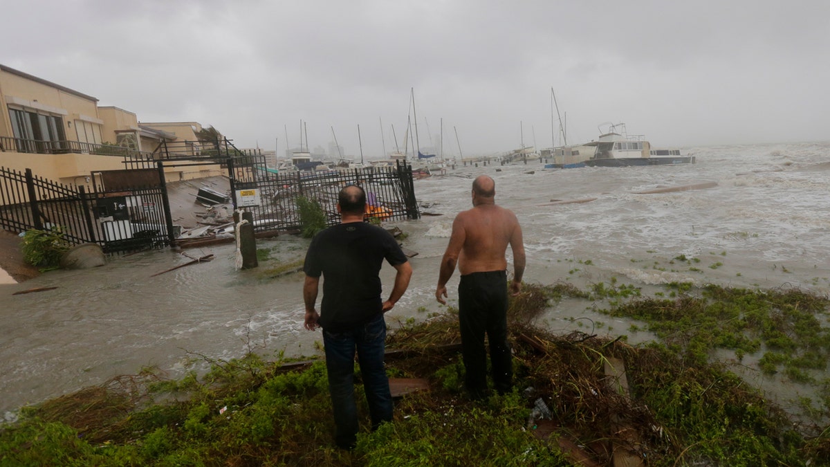 Boat owners examine the damage after the docks at the marina where their boats had been secured were destroyed as Hurricane Hanna made landfall, Saturday, July 25, 2020, in Corpus Christi, Texas.