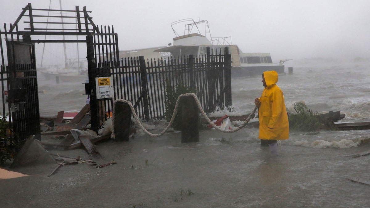 Jame Rowles examines the damage after the docks at the marina where his boat was secured were destroyed as Hurricane Hanna made landfall, Saturday, July 25, 2020, in Corpus Christi, Texas.