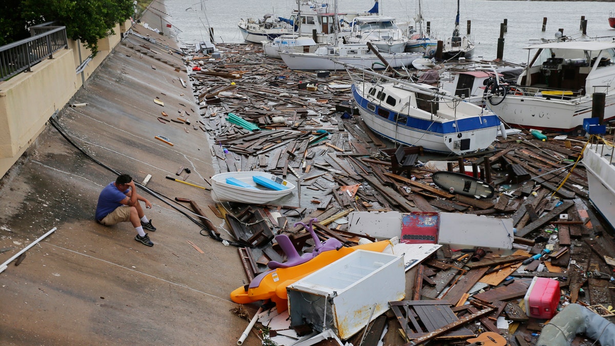 Allen Heath surveys the damage to a private marina after it was hit by Hurricane Hanna, Sunday, July 26, 2020, in Corpus Christi, Texas.