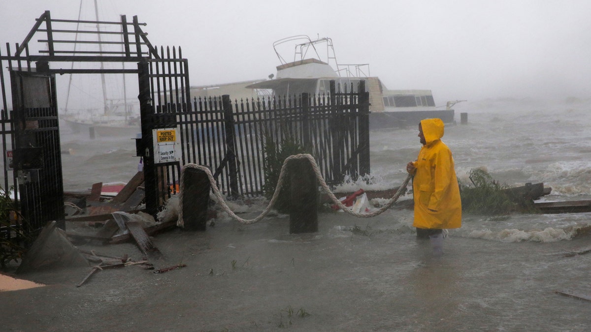 Jame Rowles examines the damage after the docks at the marina where his boat was secured were destroyed as Hurricane Hanna made landfall, Saturday, July 25, 2020, in Corpus Christi, Texas.