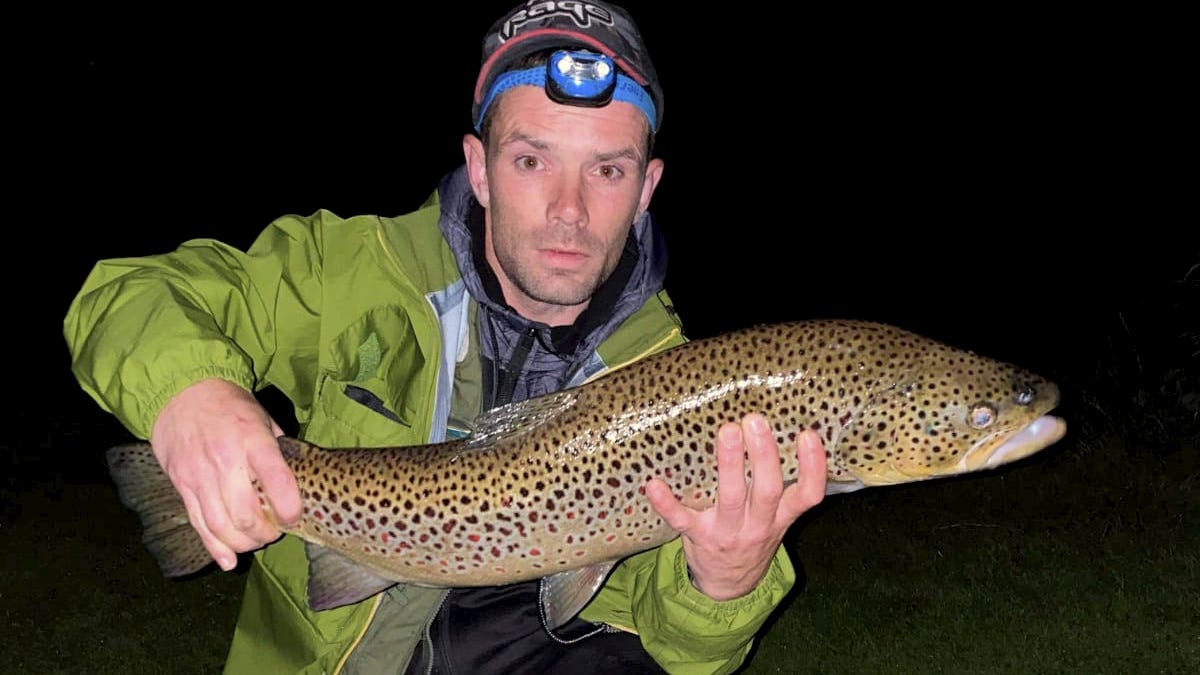 Barry Mcguigan poses with his massive wild brown trout on July 12. (SWNS)