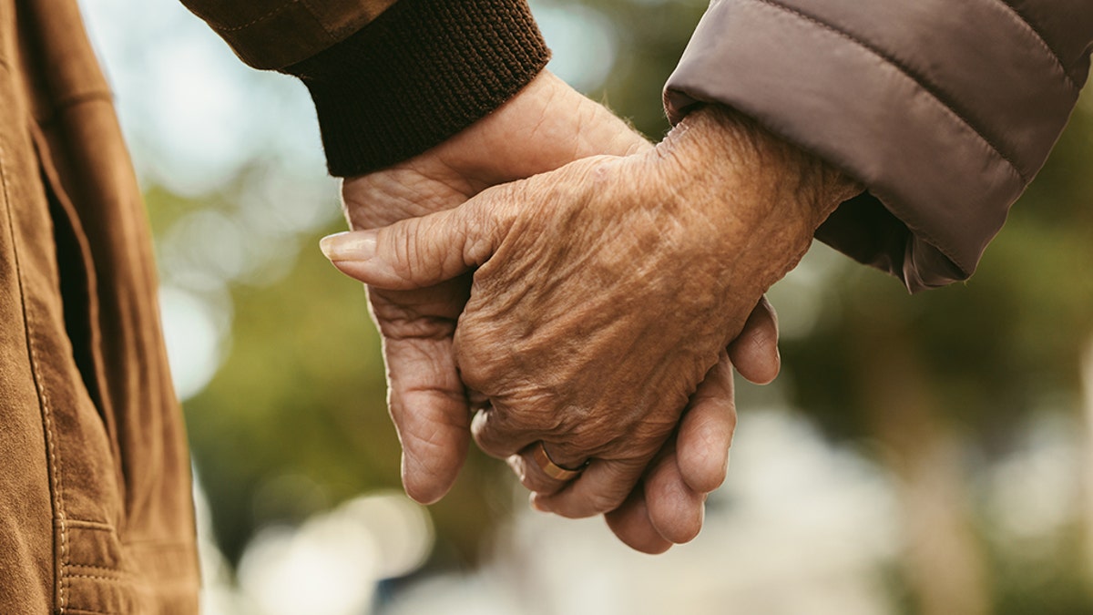 Couple holds hands