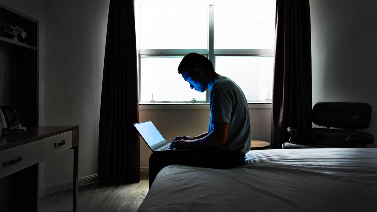 Craning over laptops on the bed or couch with rounded shoulders fatigues the muscles and predisposes the body to injury, experts say. (iStock)