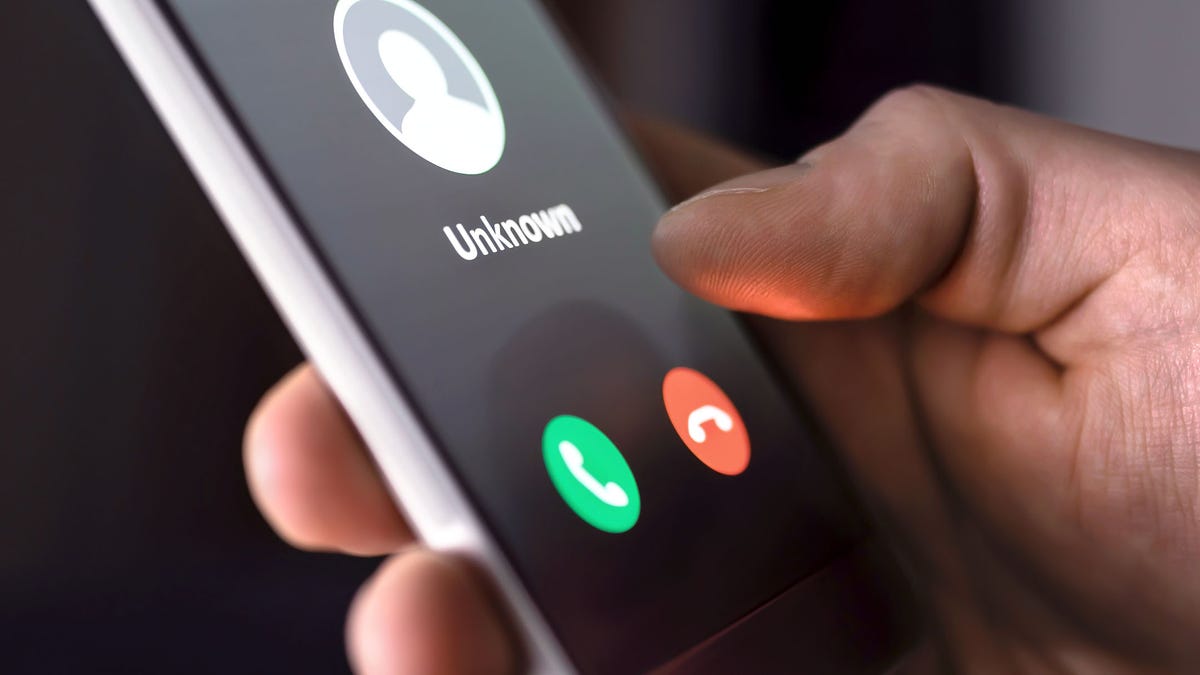 Phone call from unknown number late at night. Scam, fraud or phishing with smartphone concept. Prank caller, scammer or stranger. Man answering to incoming call.