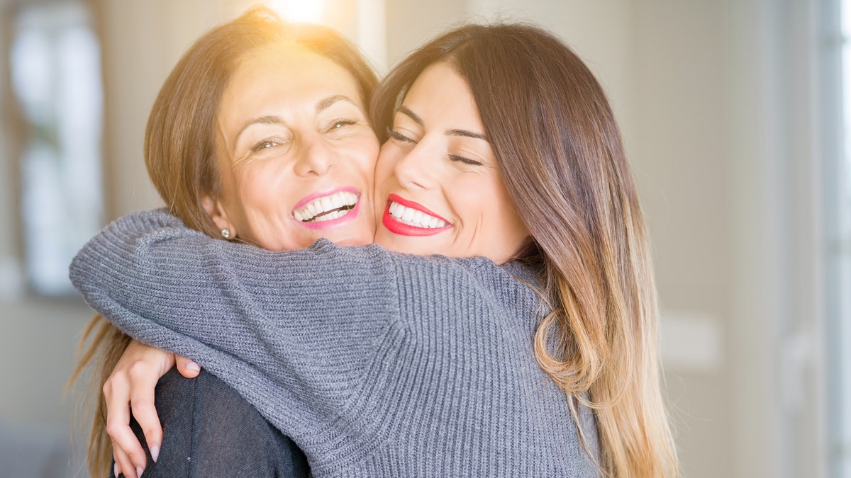 mom and daughter hugging