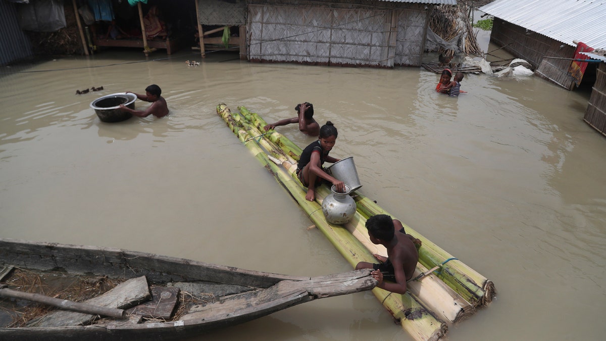 Flood affected villagers are seen near their partially submerged houses in Gagolmari village, Morigaon district, Assam, India, July 14.