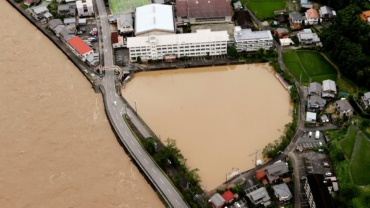 A schoolyard of a junior high school is seen flooded following heavy rains in Gero, Gifu prefecture, central Japan Wednesday, July 8, 2020.