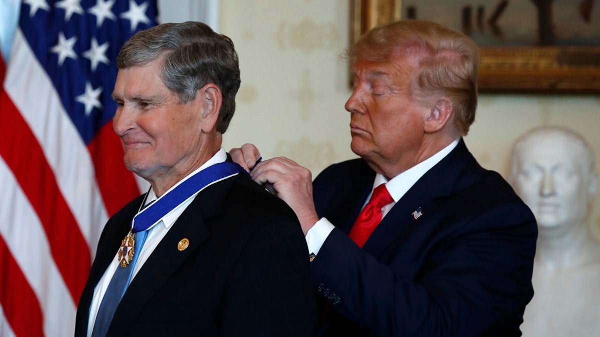 President Donald Trump presents the Presidential Medal of Freedom to Jim Ryun, in the Blue Room of the White House, Friday, July 24, 2020, in Washington. (AP Photo/Alex Brandon)