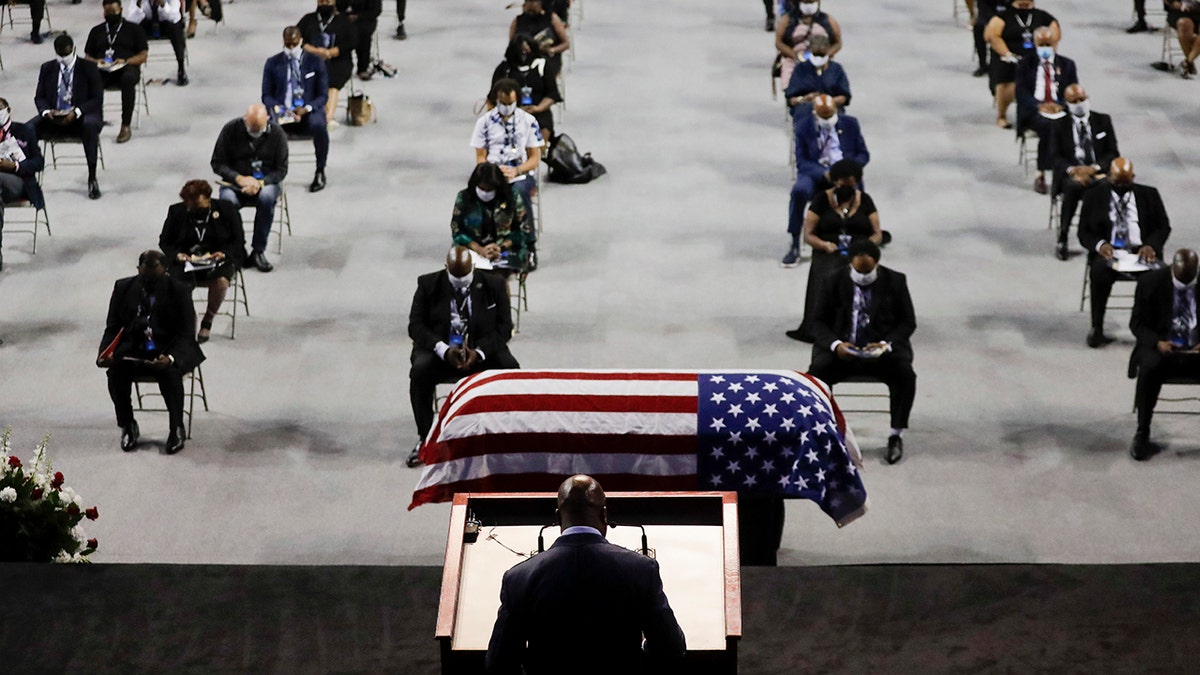 Rev. Darryl Caldwell speaks as the casket of the late Rep. John Lewis, D-Ga., lies in repose during a service celebrating "The Boy from Troy" at Troy University on Saturday, July 25, 2020, in Troy, Ala. Lewis, who carried the struggle against racial discrimination from Southern battlegrounds of the 1960s to the halls of Congress, died Friday, July 17, 2020. (AP Photo/Brynn Anderson)