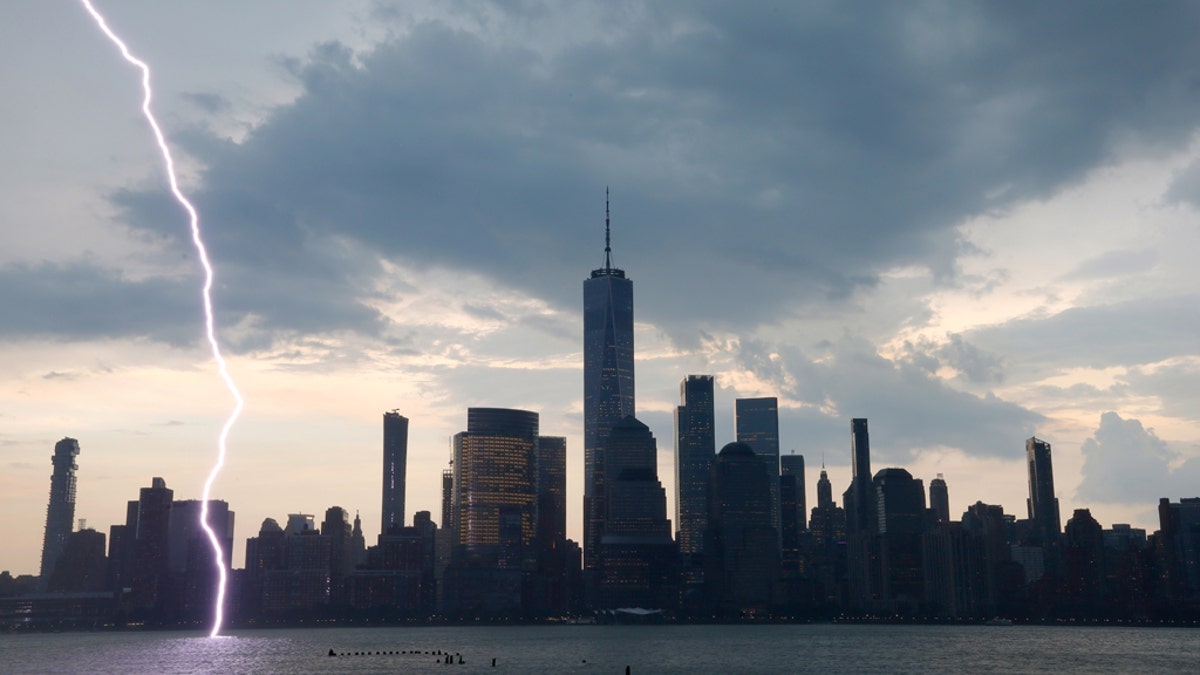 JERSEY CITY, NJ - JULY 22: A bolt of lightning hits the middle of the Hudson River in front of lower Manhattan and One World Trade Center during a thunderstorm in New York City on July 22, 2020 as seen from Jersey City, NJ. (Photo by Gary Hershorn/Getty Images)