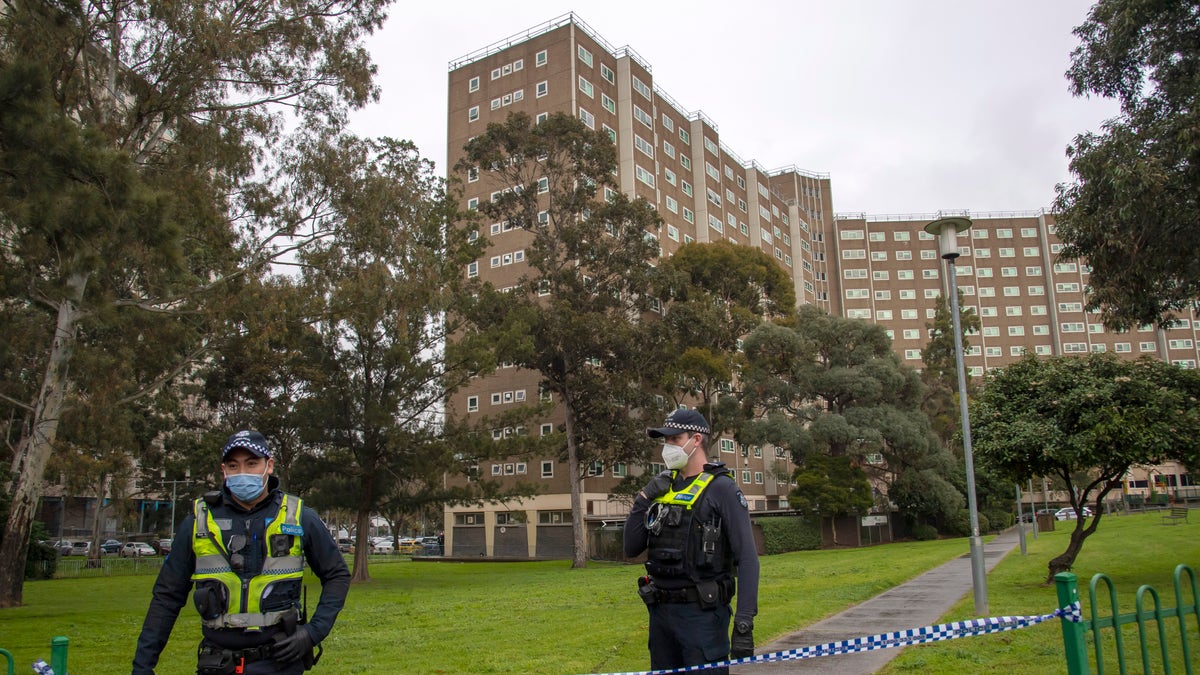 Police guard access to apartments under lockdown in Melbourne, Australia, on Monday. (AP)