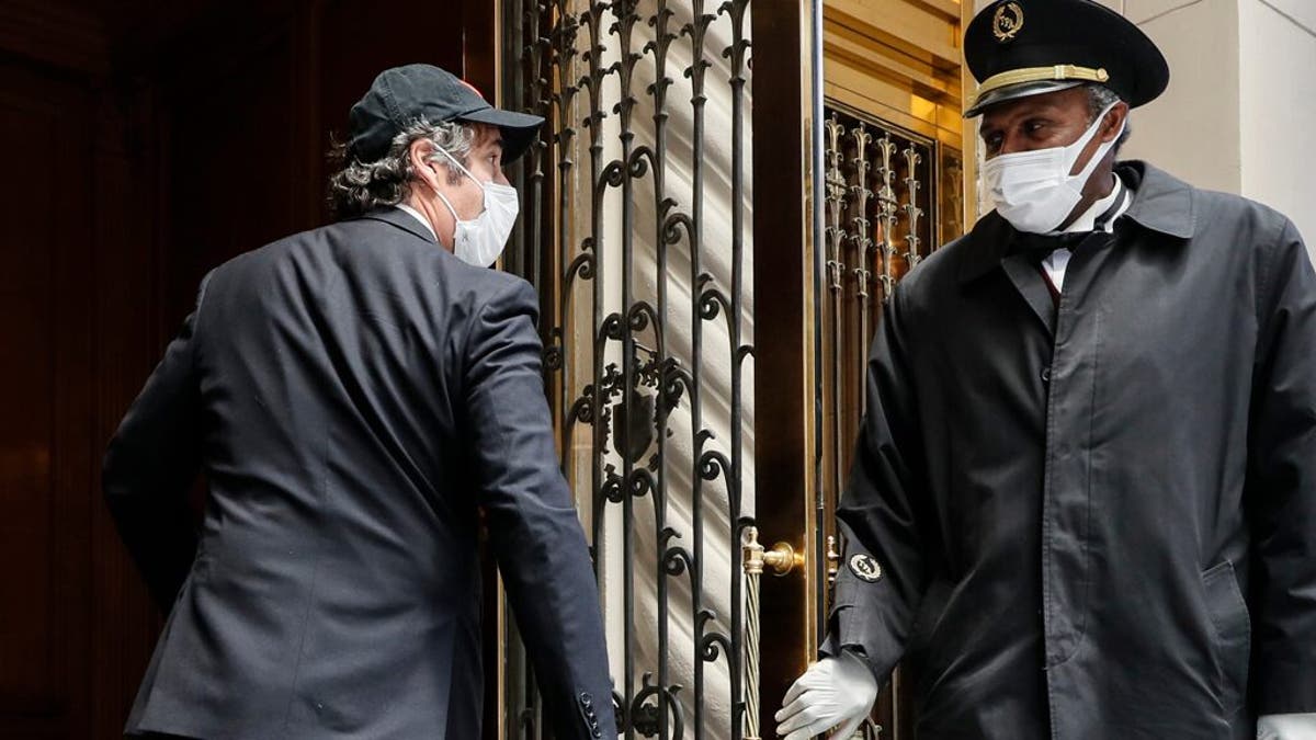 Michael Cohen arrives at his Manhattan apartment, Thursday, May 21, 2020. Cohen had been serving a federal prison sentence at FCI Otisville in New York after pleading guilty to numerous charges, including campaign finance fraud and lying to Congress. He was returned to prison -- then ordered released -- in July over a controversy about whether his tell-all about Trump violated the terms of his home confinement. (AP Photo/John Minchillo)