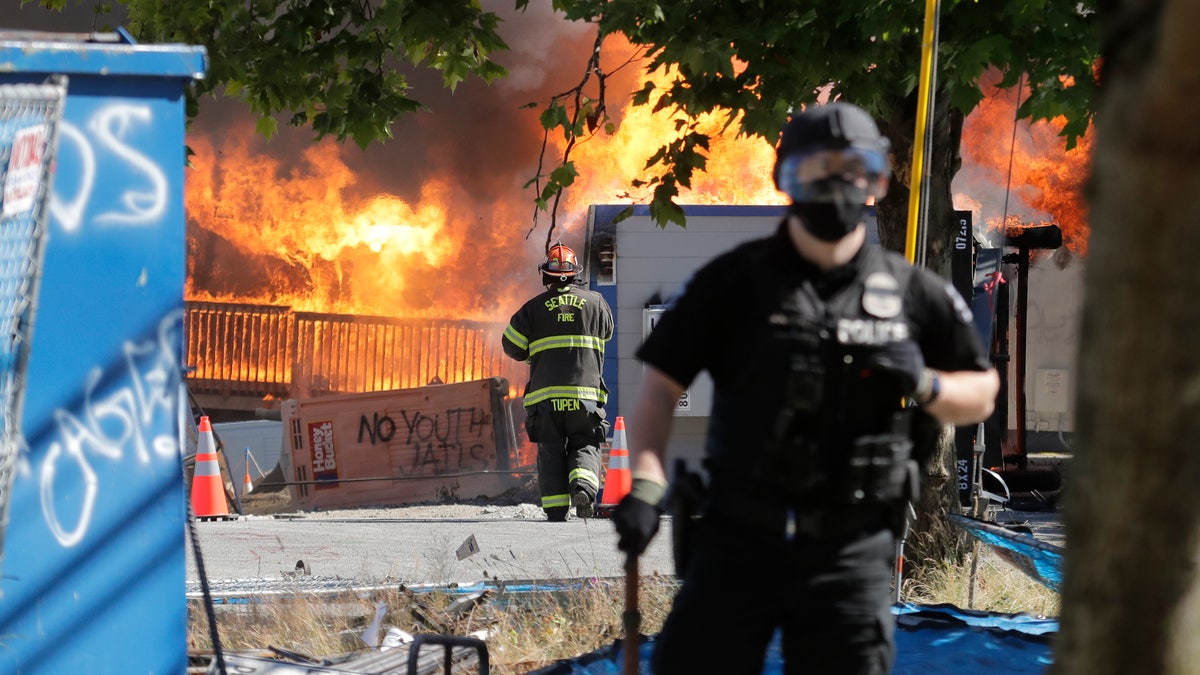 Construction buildings burn near the King County Juvenile Detention Center on Saturday, shortly after a group of protesters left the area. (AP)