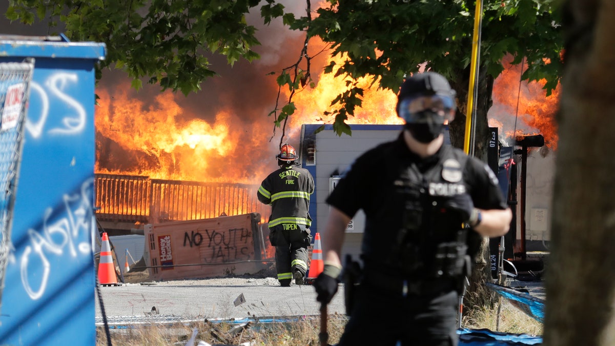 Construction buildings burn near the King County Juvenile Detention Center on Saturday, shortly after a group of protesters left the area. (AP)