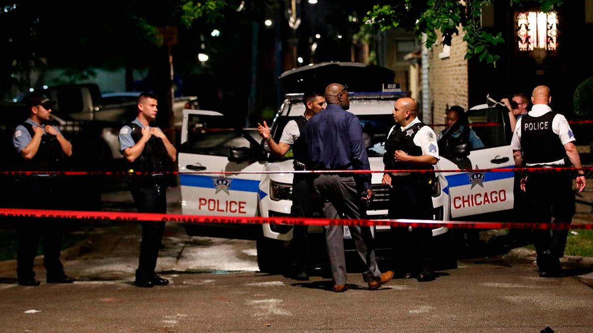 Chicago police officers investigate the scene of a shooting in Chicago, Illinois, on July 21, 2020. 